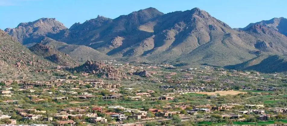 Overview of Arizona with mountain and houses below it
